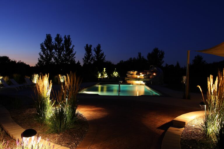 gunite pool with water slide and water falls at night