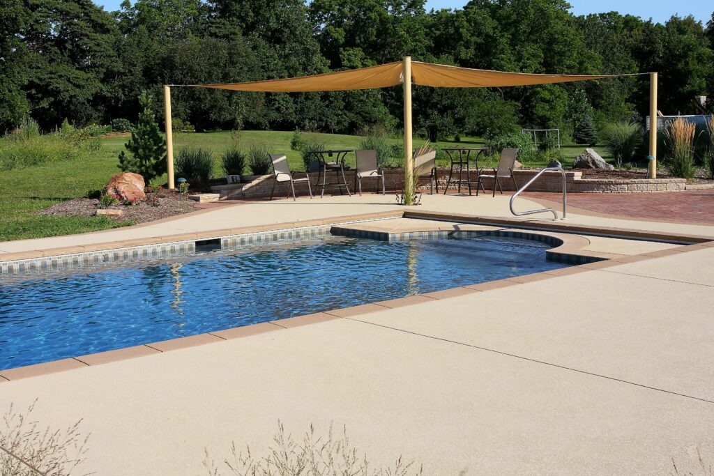 Aquarius rectangular pool with a clean light concrete deck