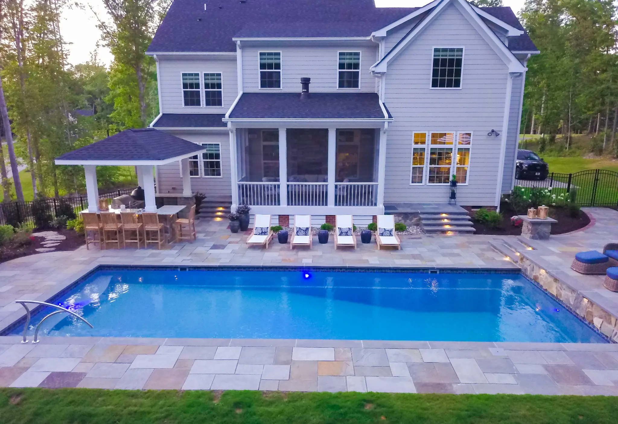 Poolside covered outdoor bar pavilion with dining and lounge areas