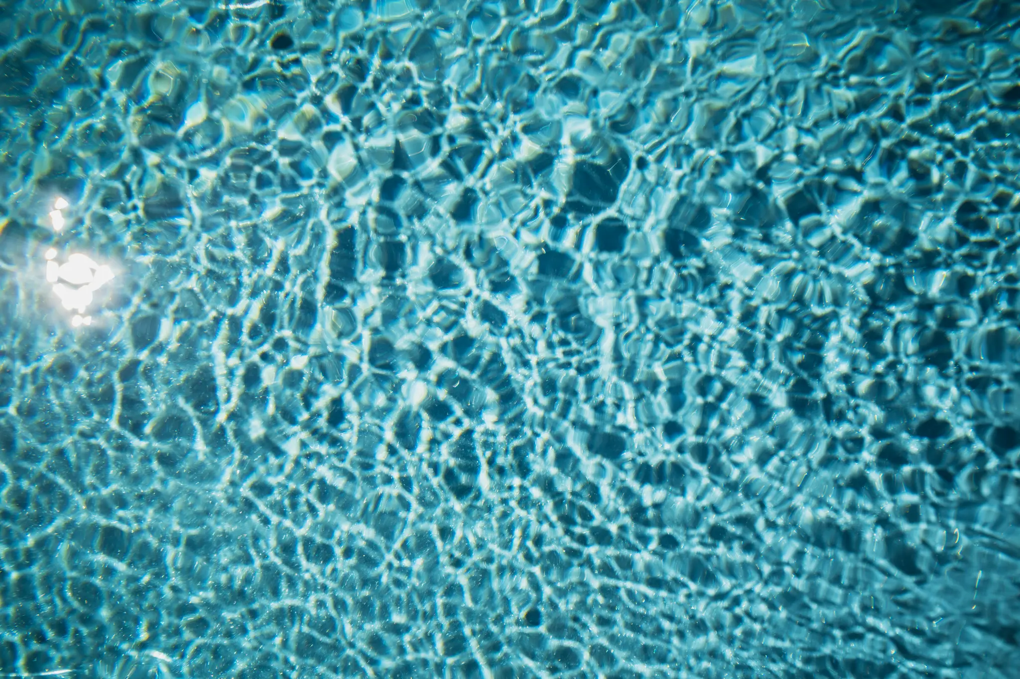 Close view of sunlit water in a River Pools M35 fiberglass pool in Granite Gray