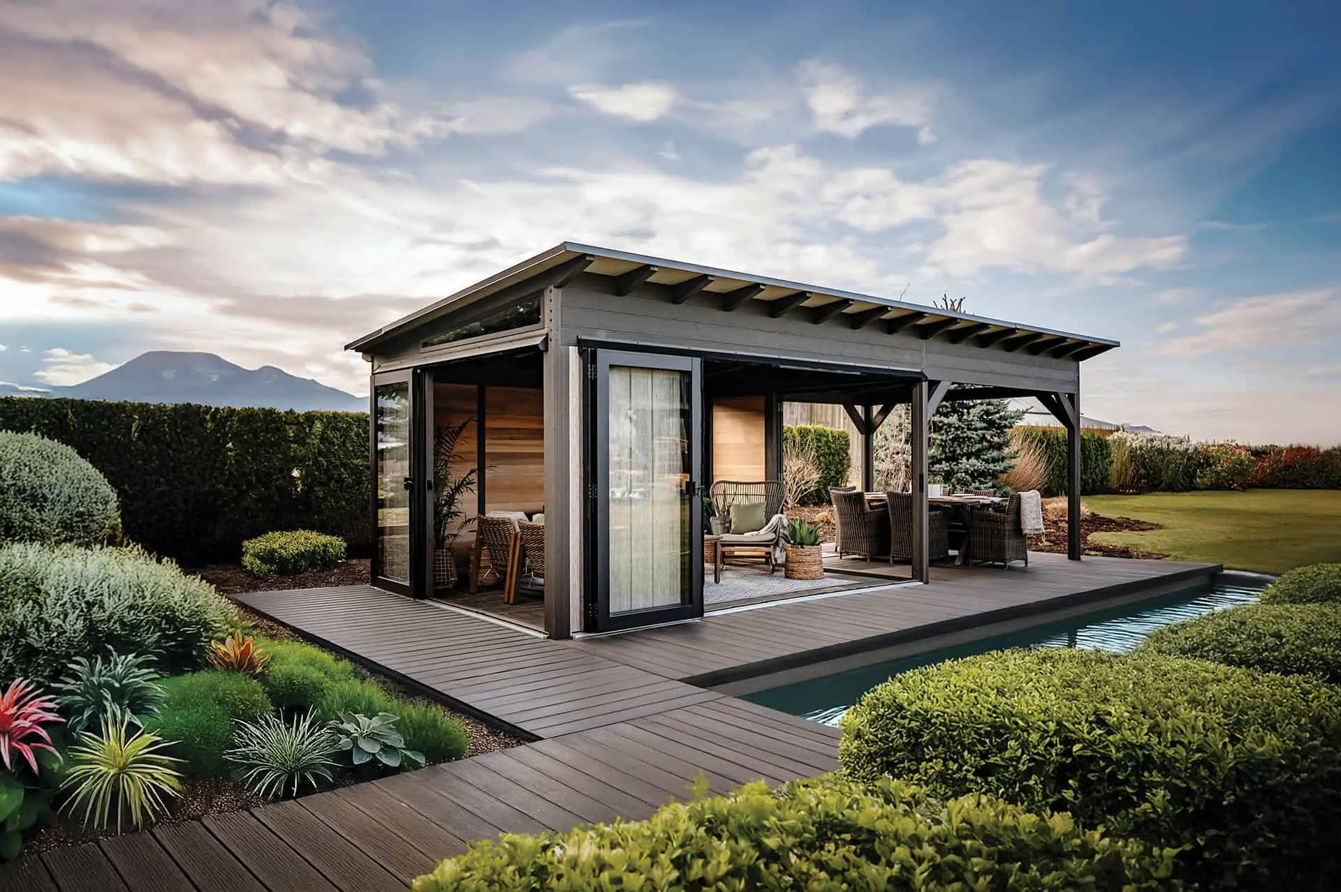 Visscher Duke enclosed outdoor living room and pool house with glass folding doors and covered veranda